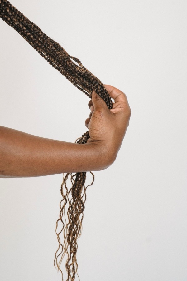 Hands holding finished micro braids